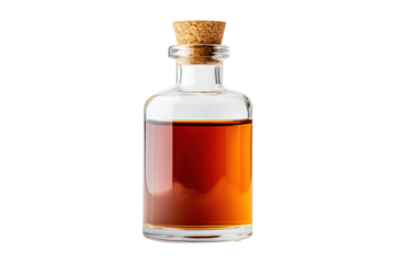 Clear glass bottle with cork filled with amber liquid, cut out