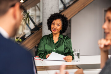 Professional Setting Conversation Featuring Confident Individuals in Office Environment