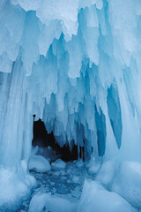 An ice cave featuring icicles that are hanging down from the ceiling