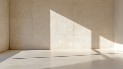 Empty room with sunlight casts shadows on light beige walls and floor