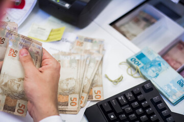 Businessman counting and exchanging money - Brazilian Real - Reais.
