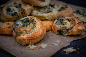 Spinach cheese puff pastry rolls on brown paper
