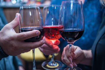 man holding a glass of red wine