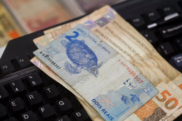 Businessman counting and exchanging money - Brazilian Real - Reais.