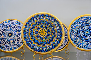 Traditional ceramics plates in a retail display at a gift shop, Seville, Spain