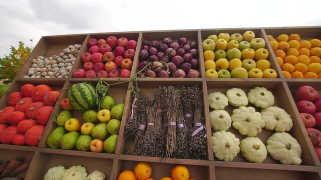 Stand with garden harvest of different fruits and vegetables and lavander