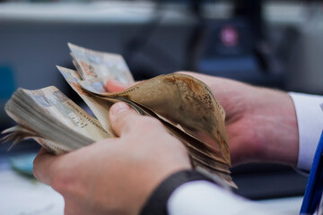 Businessman counting and exchanging money - Brazilian Real - Reais.