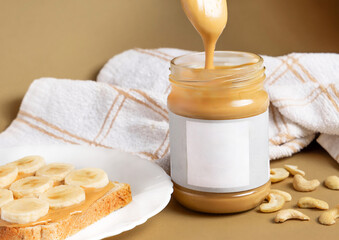 jar with peanut or pistachio cream and 2 toast with banana and strawberry slice.spoon with pasta and kitchen towel in background.woman holding with fingers one jar on shoulder.creative shooting