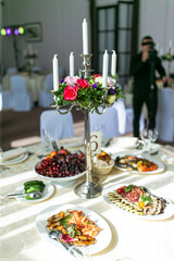 A table set with delicious food and a floweradorned candelabra