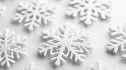Snowflakes on white background indoor high-quality imagery minimalist close-up winter aesthetic