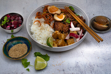 Vegetarian asian bowl with tofu, rice, seitan and carrot stir fry