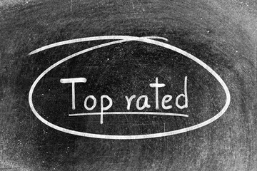 White chalk hand writing in word top rated and circle shape on blackboard background