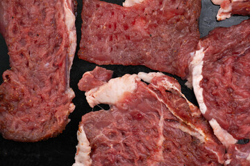 Freshly sliced raw beef cuts ready for cooking or grilling at a local butcher shop