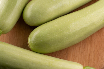 Fresh zucchini arranged on a wooden surface showcasing vibrant green colors and smooth textures