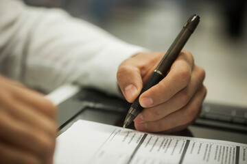 Crop shot of a business person with pen signing document