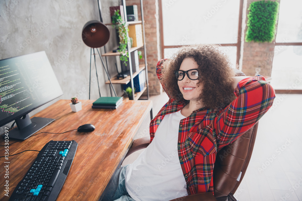 Poster successful young woman coder taking a break while working in her home office workspace