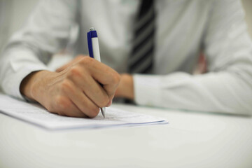 Crop shot of a business person with pen signing document
