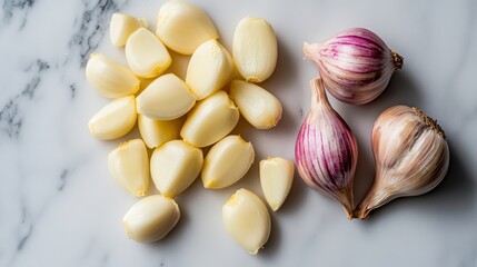 Garlic cloves and bulbs arranged on a marble surface for cooking preparations and culinary uses