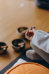 woman practicing yoga lesson with Tibetan Sound Bowl. Buddhism And Meditating Therapy