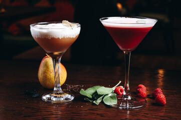 Three different beautiful cocktails in warm colors on a flower background