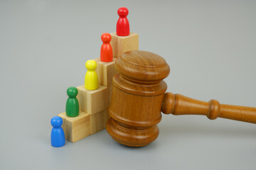 Colored people figures as workers on stair made of wooden cubes with judge gavel.