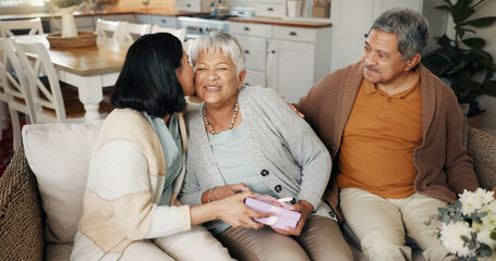 Birthday, gift or kiss with family on sofa in living room of home together for bonding or...