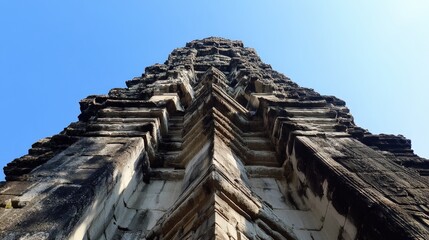 Angkor Wat rising against a clear blue sky, showing the temple grandeur and majesty