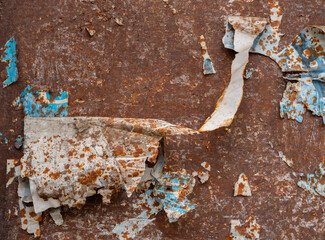 Close-up of rusty metal with peeling paint and weathered texture, ideal for backgrounds, grunge...