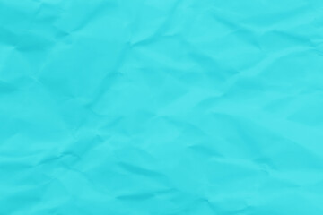 Crumpled turquoise green blue paper texture background. Wrinkled paper surface abstract background.