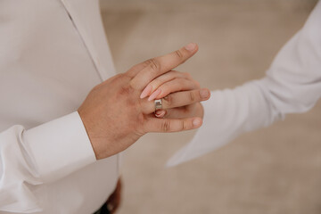 A guy puts a diamond engagement ring on his girlfriend's finger, close-up photo. An offer of a hand...