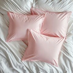 Soft pink decorative pillows resting on crisp white bedding, conveying serene bedroom styling