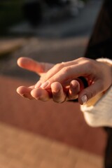 A man holds a woman's hands with wedding rings. Support for loved ones. Couple outdoor love
