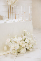 Wedding decoration in a restaurant. White flowers, serving and decor for a wedding