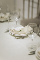 Wedding decoration in a restaurant. White flowers, serving and decor for a wedding