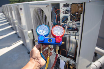 technician checks the operation of the air conditioner.	