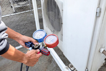 technician checks the operation of the air conditioner.	