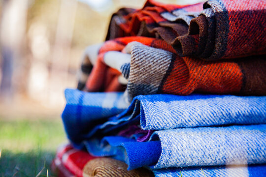 Pile of blankets on grass in winter for outdoor picnic