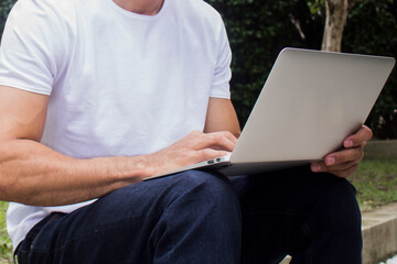 Young casual entrepreneur working on laptop at home office.