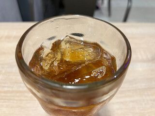 Iced Beverage Filled With Ice Cubes Sits on a Table in a Casual Dining Setting