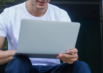 Young casual entrepreneur working on laptop at home office.