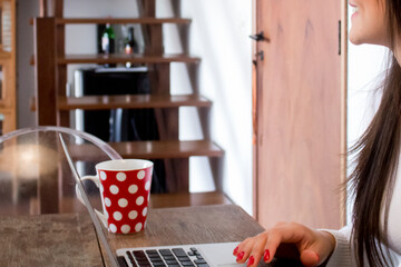 Young casual entrepreneur working on laptop at home office.