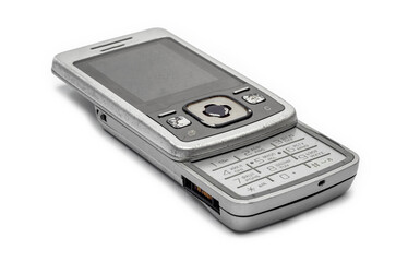 Old flip mobile phone in open position on white background for nostalgic display