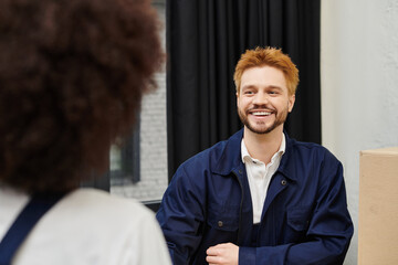 Smiles exchanged during a friendly packing and moving consultation in a contemporary space
