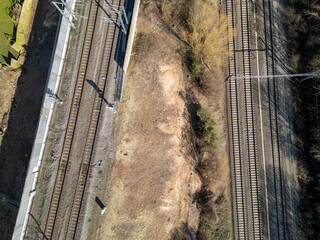 A drone view showcasing railway tracks and adjacent barren land, highlighting infrastructure and...