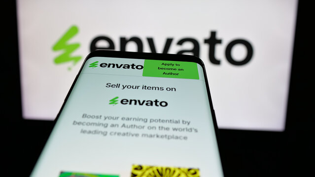 Stuttgart, Germany - 03-07-2025: Mobile phone with logo of Australian content platform company Envato on screen in front of business website. Focus on top-left of phone display.