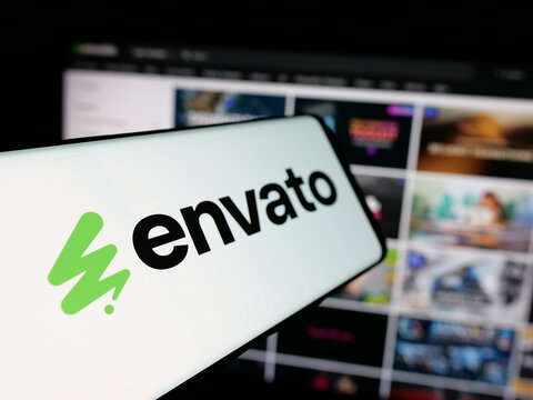 Stuttgart, Germany - 03-07-2025: Smartphone with logo of Australian content platform company Envato on screen in front of business website. Focus on left of phone display.
