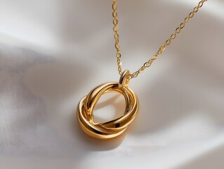 A gold necklace with interlocking Russian rings is displayed against a soft white fabric background