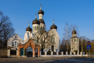 Fototapeta premium A historic old Orthodox church in Riga, Latvia, known for its traditional Russian Revival architecture, featuring distinctive onion domes, arched windows. The church stands as a significant religious 