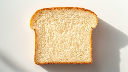Freshly sliced white bread with soft texture and light shadows