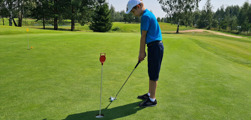 Young boys playing golf in a competitive tournament